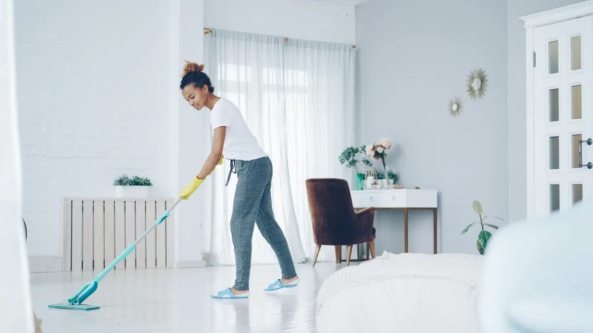 Cleaning and Maintenance at Home — The Complete Guide Woman mopping a bright home interior