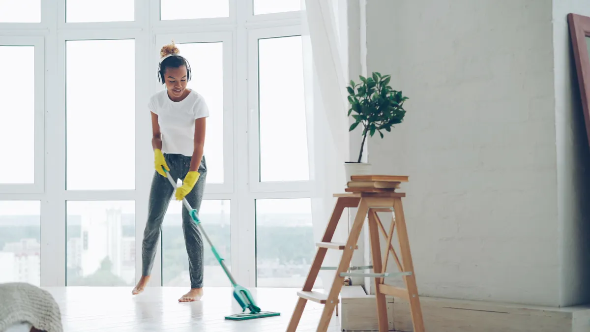 Cleaning and Maintenance at Home — The Complete Guide Person mopping a sunlit room floor
