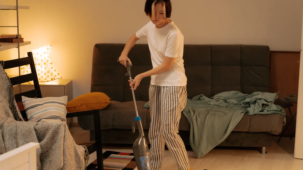 Woman vacuuming a living room floor